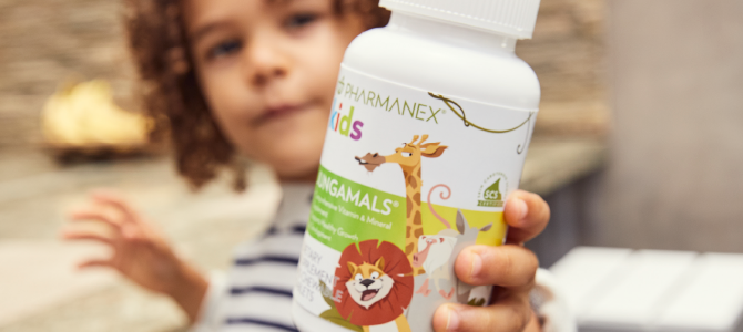 Kids MultivitaminsIn-Article Image 03 Child holding a bottle of Pharmanex Kids Jungamals by Nu Skin